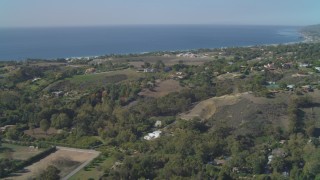 4K aerial stock footage of flying by residential neighborhoods, view of the ocean, Malibu, California Aerial Stock Footage | DCA05_132