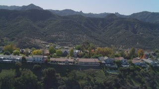 DCA05_146 - 4K aerial stock footage of fly by homes on hill near Santa Monica Mountains, Westlake Village, California