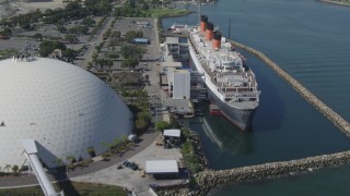 4K aerial stock footage fly away from RMS Queen Mary, reveal Carnival Cruise Lines terminal, Long Beach, California Aerial Stock Footage | DCA06_025