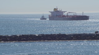 4K aerial stock footage of an oil tanker and tugboat near breakwater, Long Beach, California Aerial Stock Footage | DCA06_035