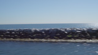 4K aerial stock footage fly away from an oil tanker, pan across breakwater, Long Beach, California Aerial Stock Footage | DCA06_037