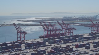 DCA06_040 - 4K aerial stock footage flyby containers, cranes, cargo ship at Port of Long Beach, California