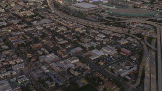 DCA07_014 - 4K aerial stock footage of flying over urban buildings near Highway 110, Downtown Los Angeles, California, twilight