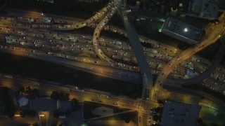 4K aerial stock footage a bird's eye flying over Highway 110, reveal Westin Bonaventure Hotel, Downtown Los Angeles, California, night Aerial Stock Footage | DCA07_038