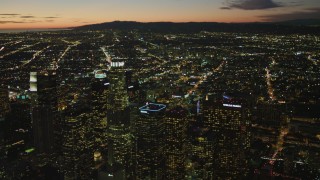 4K aerial stock footage of flying by Downtown skyscrapers, view of Los Angeles Basin, Santa Monica Mountains, California, twilight Aerial Stock Footage | DCA07_052