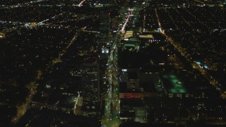 4K aerial stock footage of following Wilshire Blvd through Mid-Wilshire, Los Angeles, California, night Aerial Stock Footage | DCA07_076