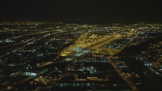 DCA07_114 - 4K aerial stock footage of flying by a train yard, Vernon, California, night