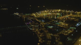 DCA07_124 - 4K aerial stock footage fly over the Port of Long Beach, approaching RMS Queen Mary, Long Beach, California, night