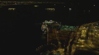 4K aerial stock footage of RMS Queen Mary, Carnival Cruise Lines building, Port of Long Beach, California, night Aerial Stock Footage | DCA07_126