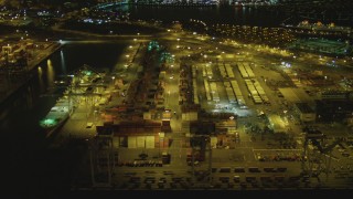 4K aerial stock footage of flying by cargo cranes, containers, Port of Long Beach, California, night Aerial Stock Footage | DCA07_129