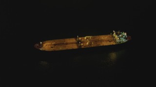 4K aerial stock footage of an orbit of an oil tanker sailing near Port of Long Beach, California, night Aerial Stock Footage | DCA07_148