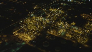 DCA07_163 - 4K aerial stock footage of flying over an oil refinery, El Segundo, California, night