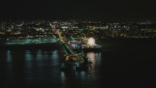 4K aerial stock footage of passing by the Santa Monica Pier, Santa Monica, California, night Aerial Stock Footage | DCA07_173