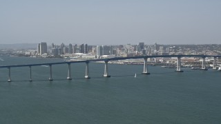 4K aerial stock footage of a reverse view of the Coronado Bridge and city skyline of Downtown San Diego, California Aerial Stock Footage | DCA08_024