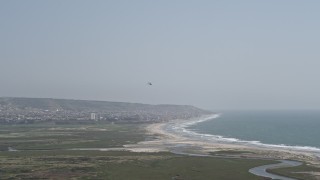 4K aerial stock footage of tracking a military helicopter over Imperial Beach, California Aerial Stock Footage | DCA08_034