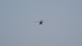 DCA08_036 - 4K aerial stock footage of tracking a military helicopter in flight over Imperial Beach, California