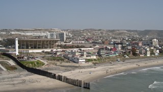 DCA08_039 - 4K aerial stock footage orbit Monumental Plaza de Toros in Tijuana, Mexico, seen from the ocean