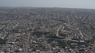 DCA08_048 - 4K aerial stock footage of a view of urban residential neighborhoods in Tijuana, Mexico