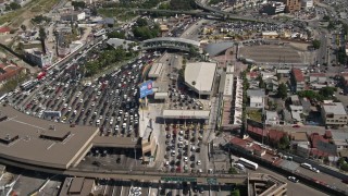 DCA08_056 - 4K aerial stock footage track traffic on the freeway to reveal the US/Mexico Border, San Ysidro