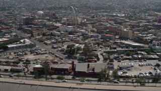 4K aerial stock footage of a reverse view of urban homes, reveal Tijuana Arch, Tijuana, Mexico Aerial Stock Footage | DCA08_061