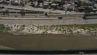 4K aerial stock footage video of a canal by the border fence, Tijuana, Mexico Aerial Stock Footage | DCA08_062