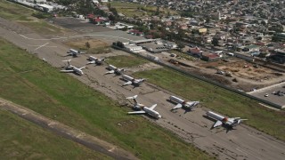 4K aerial stock footage orbit commercial airplanes at Tijuana International Airport, Mexico Aerial Stock Footage | DCA08_067