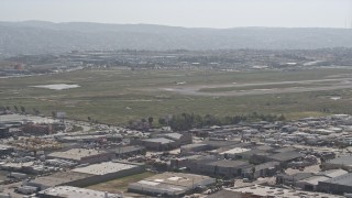 4K aerial stock footage of a passenger jet coming in for a landing at Tijuana International Airport, Mexico Aerial Stock Footage | DCA08_071