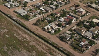 4K aerial stock footage pass urban neighborhoods by border fence, US/Mexico Border, Tijuana Aerial Stock Footage | DCA08_078