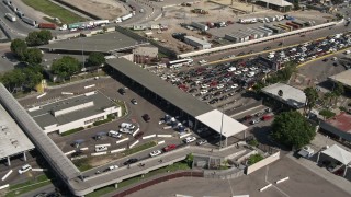 4K aerial stock footage of a reverse view of the US/Mexico Border crossing in Otay Mesa, California Aerial Stock Footage | DCA08_091