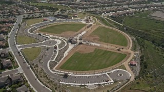 4K aerial stock footage tilt from tract homes to reveal baseball fields at sports park, Chula Vista, California Aerial Stock Footage | DCA08_120