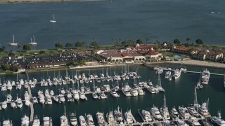 4K aerial stock footage of a reverse view of an oceanside hotel and marina, Shelter Island, California Aerial Stock Footage | DCA08_176