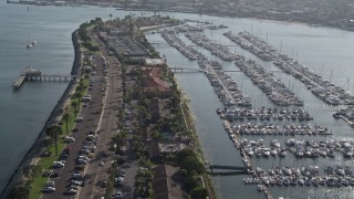 4K aerial stock footage pan across boats at a marina and tilt to reveal island hotel, Shelter Island, California Aerial Stock Footage | DCA08_177E