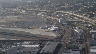 DCA08_199E - 4K aerial stock footage of tracking a cargo plane landing at San Diego International Airport, California