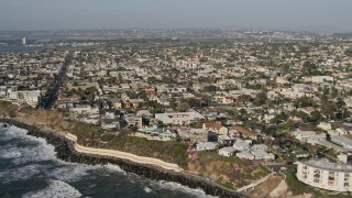 4K aerial stock footage of coastal neighborhoods by low cliffs, Point Loma, California Aerial Stock Footage | DCA08_228