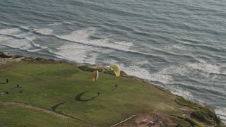 DCA08_253E - 4K aerial stock footage orbit hang gliders atop cliffs, La Jolla, California