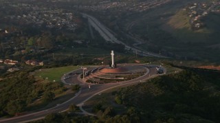 DCA08_277 - 4K aerial stock footage orbit the Soledad Cross monument in La Jolla, California, Sunset