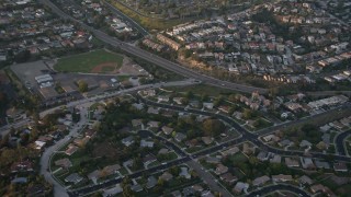 4K aerial stock footage of suburban tract homes, reveal baseball field, Pacific Beach, California, Sunset Aerial Stock Footage | DCA08_283