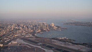 4K aerial stock footage of a high altitude approach to skyscrapers in Downtown San Diego, California, Sunset Aerial Stock Footage | DCA08_290