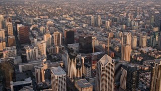 4K aerial stock footage of panning over the city while flying over skyscrapers, Downtown San Diego, California, Sunset Aerial Stock Footage | DCA08_293