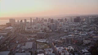 4K aerial stock footage of panning across the city skyscrapers, and orbit Downtown San Diego, California, Sunset Aerial Stock Footage | DCA08_300