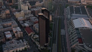 4K aerial stock footage of a condominium skyscraper complex in Downtown San Diego, California, Sunset Aerial Stock Footage | DCA08_309