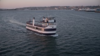 4K aerial stock footage approach and track a ferry sailing San Diego Bay, California, Sunset Aerial Stock Footage | DCA08_314