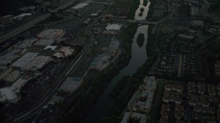 4K aerial stock footage of a reverse view of a strip mall by the San Diego River, Mission Valley, California, twilight Aerial Stock Footage | DCA08_334