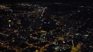 4K aerial stock footage of panning from sports stadium to skyscrapers in Downtown San Diego, California, Night Aerial Stock Footage | DCA08_352