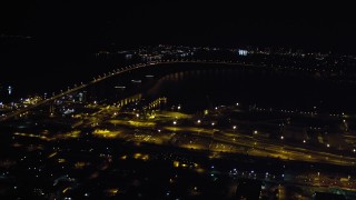 4K aerial stock footage of panning across the Coronado Bridge, the bay, and Coronado, California at night Aerial Stock Footage | DCA08_358