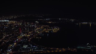 4K aerial stock footage of flying by skyscrapers and part of the bay, Downtown San Diego, California, Night Aerial Stock Footage | DCA08_373