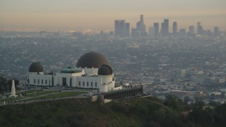 DCLA_011 - 5K aerial stock footage orbit Griffith Observatory to reveal Downtown Los Angeles skyline at sunset, California