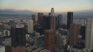 5K aerial stock footage tilt from city streets to reveal and approach Downtown Los Angeles at sunset, California Aerial Stock Footage | DCLA_025