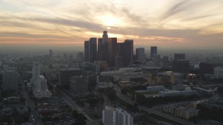 5K aerial stock footage of Downtown Los Angeles skyline with setting sun in the clouds, California Aerial Stock Footage | DCLA_034