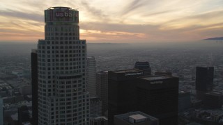 5K aerial stock footage fly over Downtown Los Angeles by US Bank Tower to approach setting sun, California Aerial Stock Footage | DCLA_038